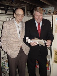 Robert Bowman (right)examines a model of a B-25, which Bowman flew early in his Air Force career. He is with Bob Warman of Springfield, who invited him to the capital city.
