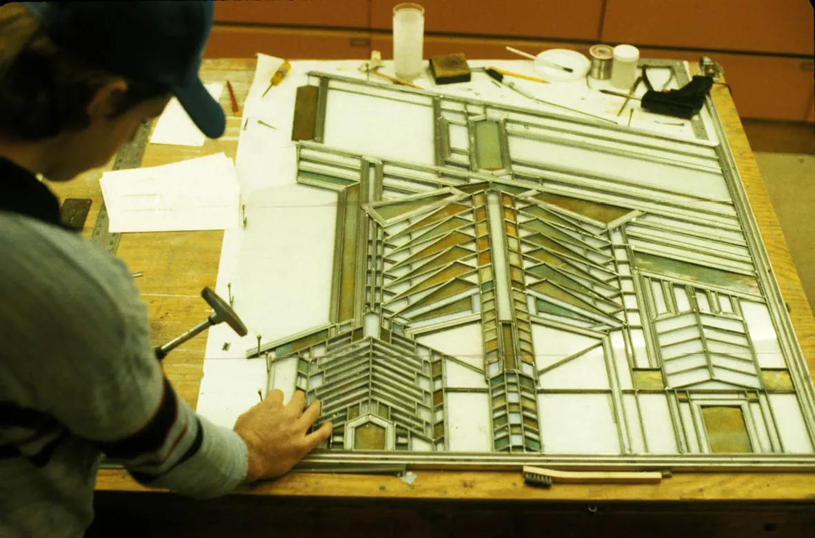 Person restoring stained glass window