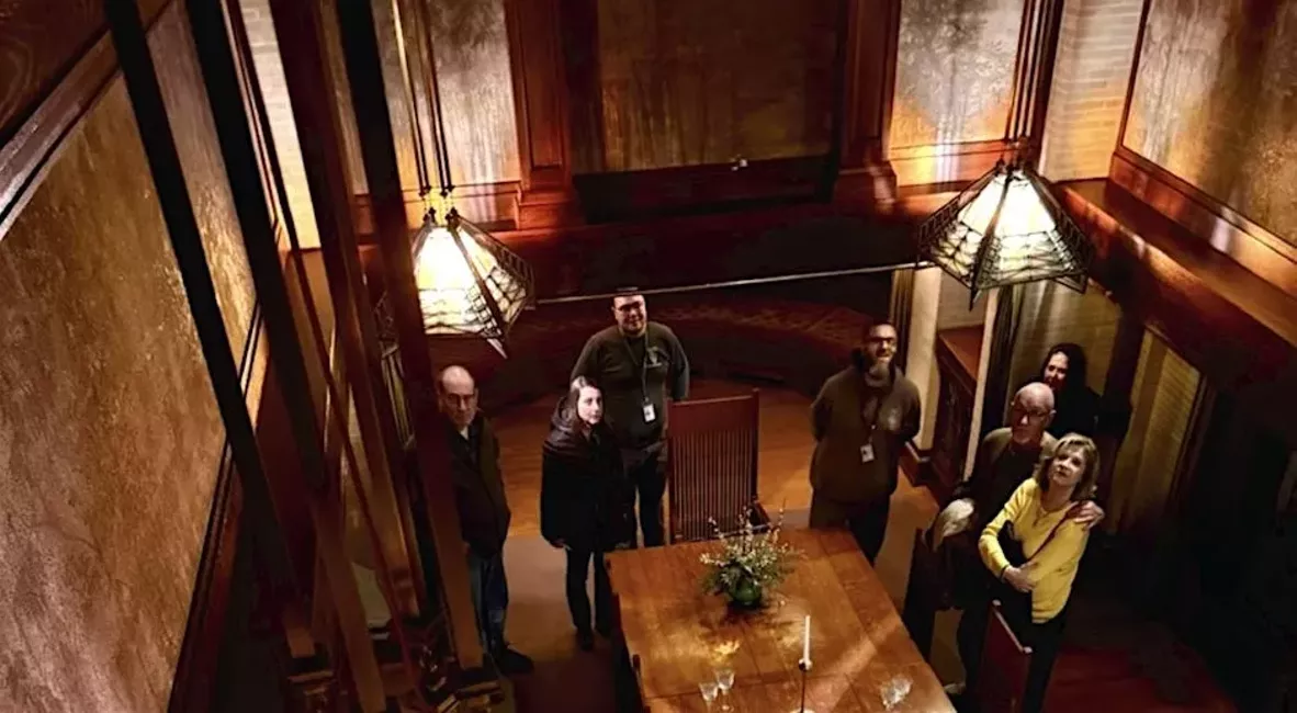 Tour guides talk to a group in the Dana-Thomas House Dining Room.